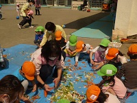 4歳児ぞう組と5歳児らいおん組が土づくりの作業をしている写真