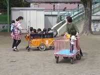 1歳児りす組が散歩用ワゴン車に乗っている写真