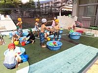 タライで遊ぶ幼児クラスの写真