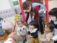 0歳児が保育園神社でお参りをしている写真です。