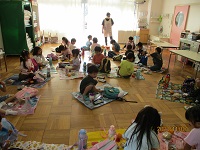 4歳児きりん組の子どもたちがホールでお弁当を広げている写真