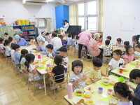 ホールで会食を楽しんでいる様子の写真