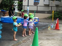 3歳児が水鉄砲をしている写真です。