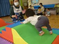 写真：システムブロックで作った山を登る0歳児