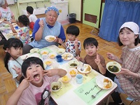 先生と一緒に給食を食べている様子の写真